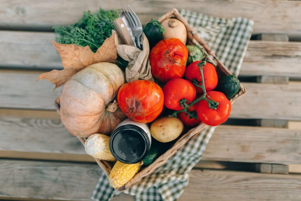 fresh vegetables and produce, placed on a wooden table.